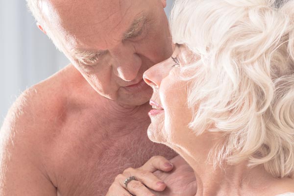 An elderly couple getting intimate