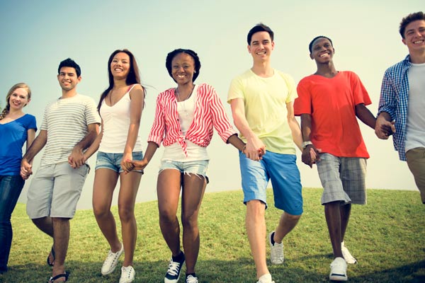 A large group of young people holding hands