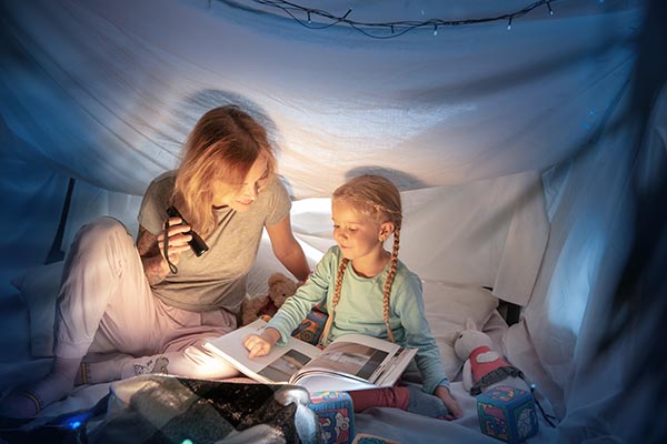 A mother and girl reading a book